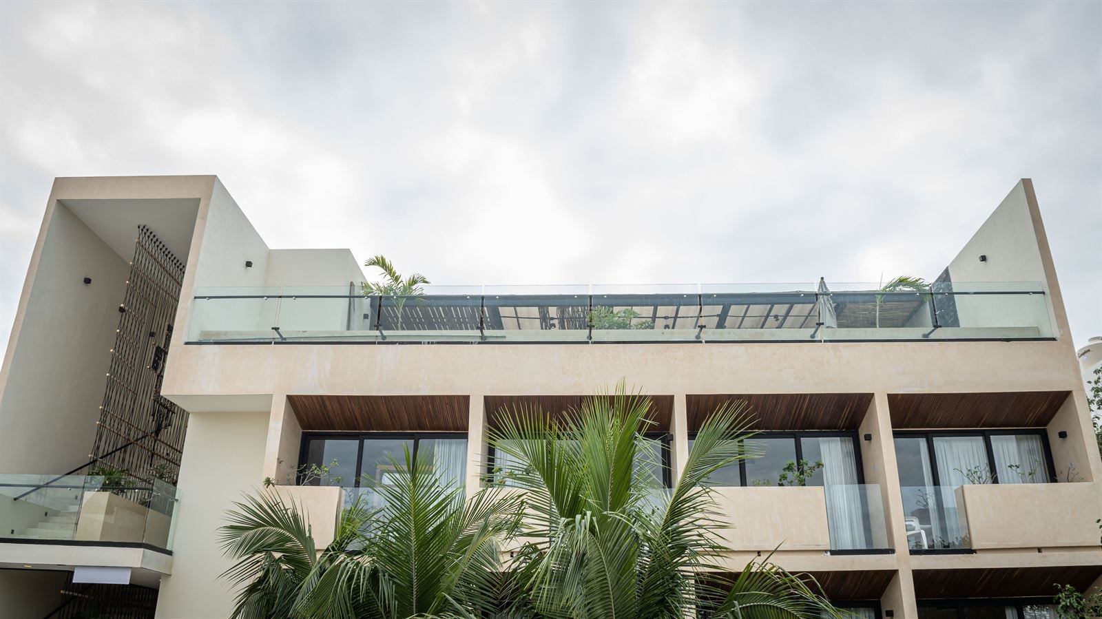 Moonshine Tulum Hotel: glass balconies around a central courtyard with palms